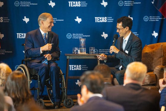 Photo of two men in a conversation.